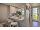 Charming kitchen with white cabinets, breakfast bar seating, and updated appliances at 3282 Mangrove Point Dr, Ruskin, FL 33570