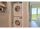 This laundry closet features a stacked washer and dryer for added convenience at 3282 Mangrove Point Dr, Ruskin, FL 33570