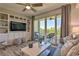 Comfortable living room with built-in shelving and sliding doors to a balcony with seating at 3282 Mangrove Point Dr, Ruskin, FL 33570
