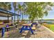 Inviting outdoor deck area with picnic tables, ideal for Gathering picnics, gatherings, and enjoying the beautiful waterfront views at 3282 Mangrove Point Dr, Ruskin, FL 33570