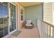 Cozy patio area with comfortable seating, a small table, and sliding glass doors at 3282 Mangrove Point Dr, Ruskin, FL 33570