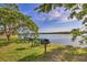 Scenic waterfront picnic area with barbecue grills and tables, providing a wonderful space for outdoor entertaining and relaxation at 3282 Mangrove Point Dr, Ruskin, FL 33570