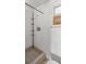 Basic bathroom features include shower, tiled floor and walls, with a small window at 3348 Clydesdale Dr, Holiday, FL 34691