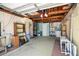 Functional garage space for parking and storage, with visible utilities and shelving at 3348 Clydesdale Dr, Holiday, FL 34691