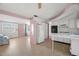 Open-concept kitchen with white cabinets and views into the living area at 3348 Clydesdale Dr, Holiday, FL 34691