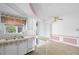 Well-lit kitchen offering white cabinets, matching appliances, and convenient serving bar at 3348 Clydesdale Dr, Holiday, FL 34691