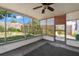 Enclosed porch with a ceiling fan and views of the backyard and fence at 3348 Clydesdale Dr, Holiday, FL 34691