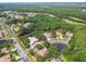 Aerial view of the neighborhood showcasing lush greenery, ponds, and well-maintained homes at 3351 Bristol Pl, Tarpon Springs, FL 34688