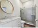 Bright bathroom featuring a large mirror, glass shower, and single vanity at 3351 Bristol Pl, Tarpon Springs, FL 34688