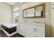 Bathroom with a large vanity, granite counters, soaking tub, and an arched window at 3351 Bristol Pl, Tarpon Springs, FL 34688
