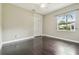 Bedroom with a window, closet, and dark hardwood floors at 3351 Bristol Pl, Tarpon Springs, FL 34688