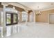 Open foyer with tile flooring, decorative columns, and glass double doors leading to the front entrance at 3351 Bristol Pl, Tarpon Springs, FL 34688