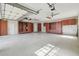 Spacious garage with ample storage cabinets and shelving and two ceiling fans at 3351 Bristol Pl, Tarpon Springs, FL 34688