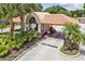 Welcoming gate house entrance to the community, surrounded by lush landscaping and palm trees at 3351 Bristol Pl, Tarpon Springs, FL 34688
