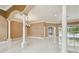 Open-concept living space featuring tile flooring, elegant columns, and abundant natural light at 3351 Bristol Pl, Tarpon Springs, FL 34688
