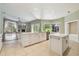 Inviting living room with hard wood floors, gas fireplace, and views of the screened-in lanai at 3351 Bristol Pl, Tarpon Springs, FL 34688