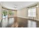 Spacious living room with hardwood floors and natural light from the sliding glass doors to the pool at 3351 Bristol Pl, Tarpon Springs, FL 34688