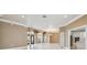 Bright living room with white tile floors, tan walls, and modern archway leading to the front door at 3351 Bristol Pl, Tarpon Springs, FL 34688