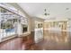 Open living room featuring hard wood floors, fireplace, and views of the outdoor pool at 3351 Bristol Pl, Tarpon Springs, FL 34688