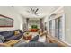 Well-lit living room featuring an open floorplan, comfortable seating, and an inviting atmosphere at 3506 Cordgrass Dr, Valrico, FL 33596
