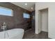 Contemporary bathroom with a stylish soaking tub and dark tile walls at 3752 Arkansas Ne Ave, St Petersburg, FL 33703