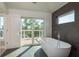 Modern bathroom featuring a soaking tub and sliding glass doors to the outdoor deck at 3752 Arkansas Ne Ave, St Petersburg, FL 33703