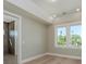 Neutral bedroom with two windows; doorway to a modern bathroom at 3752 Arkansas Ne Ave, St Petersburg, FL 33703