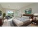 Bright main bedroom with sliding doors that lead to a balcony and a decorative accent wall at 3752 Arkansas Ne Ave, St Petersburg, FL 33703