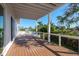 Covered deck with a white ceiling, wood floors, and white railings at 3752 Arkansas Ne Ave, St Petersburg, FL 33703