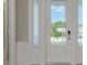 Bright entryway featuring a modern glass-paneled door and crisp white trim at 3752 Arkansas Ne Ave, St Petersburg, FL 33703