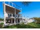 A stunning view of the rear of the house, showcasing its patio and two-story deck with a metal cable railing at 3752 Arkansas Ne Ave, St Petersburg, FL 33703