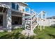 Stairway on the exterior of this beautiful home with white wood and cable railing on a grassy lawn at 3752 Arkansas Ne Ave, St Petersburg, FL 33703
