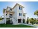 Inviting three-story home featuring a covered porch, neat landscaping, and ample under-house parking at 3752 Arkansas Ne Ave, St Petersburg, FL 33703