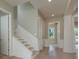 Elegant hallway featuring light wood floors, white trim, and a staircase leading to upper level at 3752 Arkansas Ne Ave, St Petersburg, FL 33703