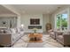 Bright living room with modern fireplace, plush seating, and sliding glass doors at 3752 Arkansas Ne Ave, St Petersburg, FL 33703