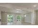 Bright and airy living room with light wood floors and large sliding glass doors at 3752 Arkansas Ne Ave, St Petersburg, FL 33703