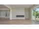 Open concept living room with a modern fireplace and sliding glass doors to the outside at 3752 Arkansas Ne Ave, St Petersburg, FL 33703