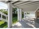A beautiful patio area with white columns and a stairway entrance to the main house at 3752 Arkansas Ne Ave, St Petersburg, FL 33703