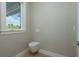 Clean powder room featuring a modern wall-mounted toilet, light wood flooring, and a serene color palette at 3752 Arkansas Ne Ave, St Petersburg, FL 33703