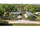 Aerial perspective of property featuring house, secondary structure, and well-defined boundaries amidst greenery at 39252 Kimberly Ave, Zephyrhills, FL 33540