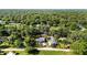 Expansive aerial view highlighting property's location surrounded by lush greenery and neighboring homes at 39252 Kimberly Ave, Zephyrhills, FL 33540