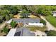 High-angle shot showcasing property's home, second building, and boundaries surrounded by trees at 39252 Kimberly Ave, Zephyrhills, FL 33540
