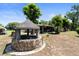 Unique backyard well feature with stone accents and lush green surroundings in the yard at 39252 Kimberly Ave, Zephyrhills, FL 33540