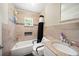 Well-lit bathroom featuring a shower-tub combo at 39252 Kimberly Ave, Zephyrhills, FL 33540