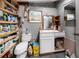 View of the bathroom featuring a white sink, toilet, and shelves for storage at 39252 Kimberly Ave, Zephyrhills, FL 33540