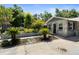 Charming stone-clad home with well-manicured front yard, showcasing inviting curb appeal at 39252 Kimberly Ave, Zephyrhills, FL 33540