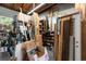 View of garage featuring ample storage shelves, wood-beam ceiling, and concrete flooring at 39252 Kimberly Ave, Zephyrhills, FL 33540