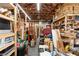 Spacious garage featuring ample storage shelves, wood-beam ceiling, and concrete flooring at 39252 Kimberly Ave, Zephyrhills, FL 33540