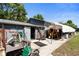 Exterior of the home's gray garage and workshop area with open and closed doors at 39252 Kimberly Ave, Zephyrhills, FL 33540