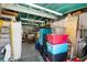 Garage interior with stacked storage, shelving and door to exterior of home at 39252 Kimberly Ave, Zephyrhills, FL 33540